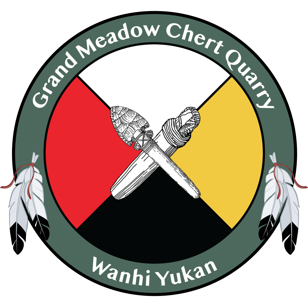 Logo of the Grand Meadow Chert Quarry, Wanhi Yukan. Depicts a circle with feathers on both sides. The circle is divided into four different colors; white, red, yellow, and black. In the center are chert tool artifacts.